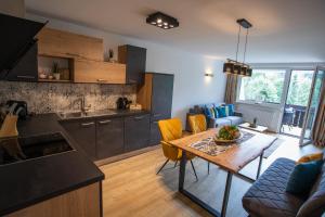 eine Küche und ein Wohnzimmer mit einem Tisch und Stühlen in der Unterkunft Apartment Vera in Saalfelden am Steinernen Meer