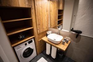 a bathroom with a sink and a washing machine at Apartment Vera in Saalfelden am Steinernen Meer