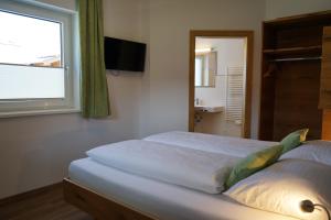 Ein Bett oder Betten in einem Zimmer der Unterkunft Bergfink apartments