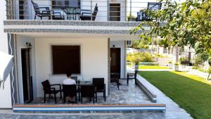 a man sitting at a table in a house at House Anna Houhlia in Vourvourou