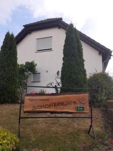 a sign in front of a house with a building at Appartement Schönberger in Rodder