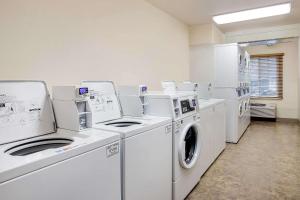 a laundry room with white machines and a window at WoodSpring Suites Asheville in Asheville