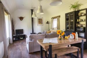 a living room with a table and a couch at Hayloft in Cheddar