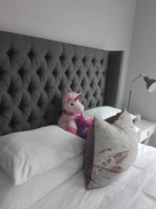 a stuffed animal sitting on top of a bed at EGRETS` ĂRK in Gansbaai