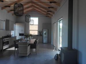 a kitchen and dining room with a table and chairs at EGRETS` ĂRK in Gansbaai