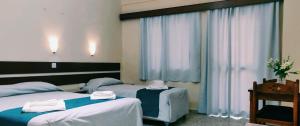 Voodi või voodid majutusasutuse Minaides Hotel toas