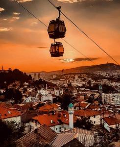 a gondola ride over a city at sunset at Sarajevo, Stari Grad, Apartment in Sarajevo