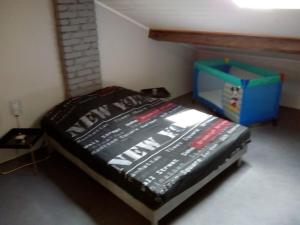 a bedroom with a bed with a box on it at Duplex 2 au centre de MIRECOURT in Mirecourt
