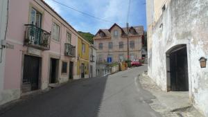 an empty street in a town with buildings at ribeira dos marinheiros amarelo in Sintra +36 photos