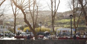 a parking lot with tables and cars in a park at ribeira dos marinheiros amarelo in Sintra