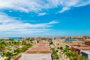 a cityscape of a resort with palm trees and the ocean at Fishing Lodge Cap Cana in Punta Cana