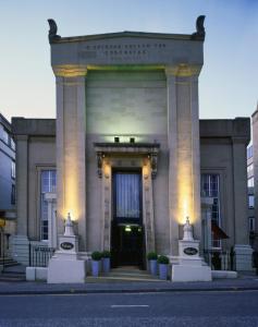 a large building with a front door with lights at Malmaison Glasgow in Glasgow