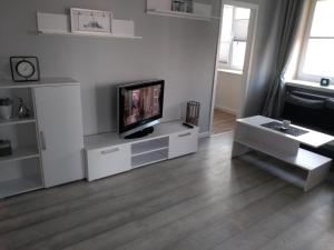 a living room with a television on a white entertainment center at Apartament Centrum in Radom