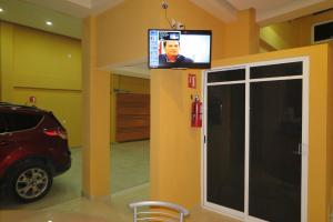 a tv on a wall in a room with a car at Hotel BONADAY Inn in Ometepec