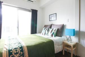 Postel nebo postele na pokoji v ubytování Chiyo apartment