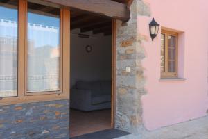 an open door to a living room with a couch at Apartamentos Rurales Caxila in Setienes