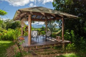 an outdoor patio area with a table and chairs at Epiphyte B & B in Cape Tribulation