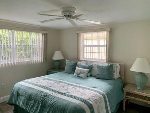 a bedroom with a bed with a ceiling fan at Island House Beach Resort 34 in Siesta Key
