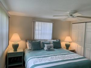 a bedroom with a bed with two lamps and a window at Island House Beach Resort 34 in Siesta Key