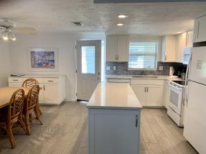 a kitchen with white appliances and a table and chairs at Island House Beach Resort 32 in Siesta Key
