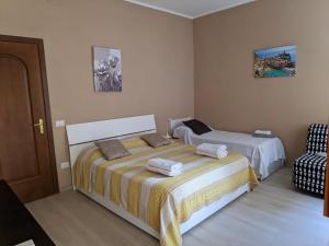 a bedroom with two beds and a chair at B&B Gina Trastevere in Rome