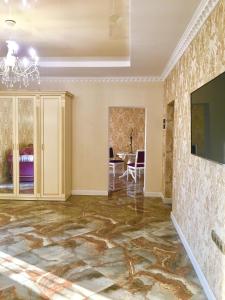 a living room with a marble floor and a chandelier at Люкс в Жмеринке in Zhmerynka