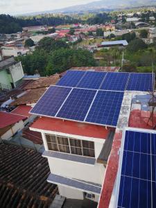 an array of solar panels on the roof of a building at Hotel Chalet in Chichicastenango