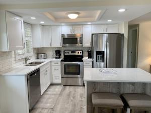 a kitchen with white cabinets and stainless steel appliances at Island House Beach Resort 34 in Siesta Key