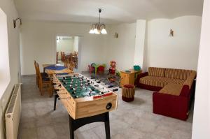 a living room with a foosball game on a table at Montana-Ederics Vendégház in Balatonederics