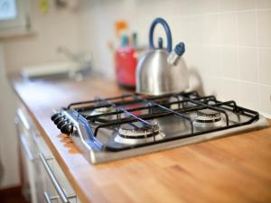 a stove top with a tea kettle on top of it at B&B Mama Rò in Cesena
