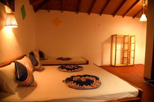 two beds in a room with two beds sidx sidx sidx at Prime Surfers Bungalow in Arugam Bay