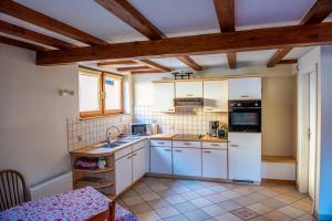 a kitchen with white appliances and a table in a room at Chez René in Ammerschwihr