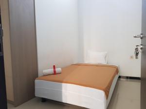 
A bed or beds in a room at Villetta House Syariah
