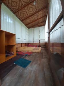 a large room with a bed and a large window at Bua Guesthouse Tangkahan in Tangkahan
