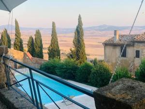 
a view from the balcony of a house overlooking the water at Relais Il Chiostro Di Pienza in Pienza
