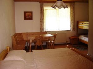 a bedroom with a bed and a table and a desk at Gasthof Zum heiligen Nikolaus in Haibach ob der Donau