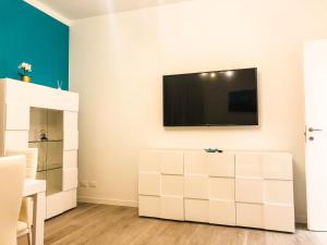 sala de estar con TV y tocador blanco en A casa di Brenda, en Chiavari
