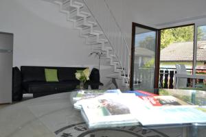 a living room with a couch and a glass table at Ferienwohnung Stimmer in Grainau