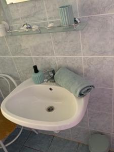a bathroom sink with a towel on top of it at Mátrai Vadászház 2 in Mátraterenye