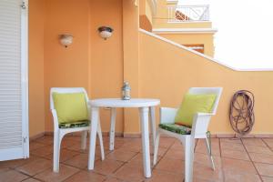 two chairs and a table and a table and chairs at Colonial Suite in Adeje
