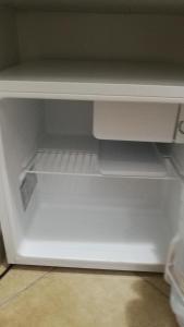 an empty white refrigerator with its door open at Camera Privata in Pomezia
