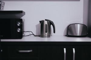a kitchen counter with a microwave and a toaster at Urban Apartment in Oradea