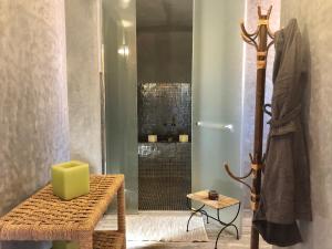 a bathroom with a shower with a green box on a bench at Domaine de Tameslohte in Tameslouht +54 photos