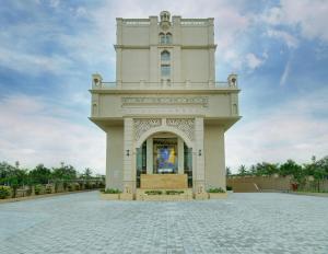 a large white building with a clock tower at Lemon Tree Premier, Dwarka in Dwarka