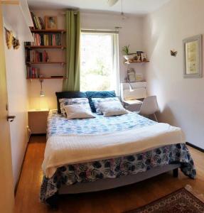 a bedroom with a large bed with a window at Entire private 2 rooms apartment in city center of Malmö close to Copenhagen in Malmö