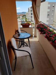 a balcony with a table and chairs and a window at Studio Apartment Lili in Zadar