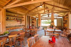 a dining room with wooden tables and chairs at Pousada Fazenda Florença in Conservatória