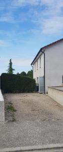 a large white building with a garage in a driveway at L ATELIER in Courtisols