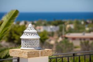 a lighthouse on a balcony with a view of the ocean at Tenuta Aletheia B&B in Alliste +28 photos