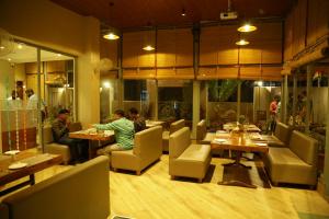 a restaurant with people sitting at tables in a room at The Jawai Gateway in Sheoganj